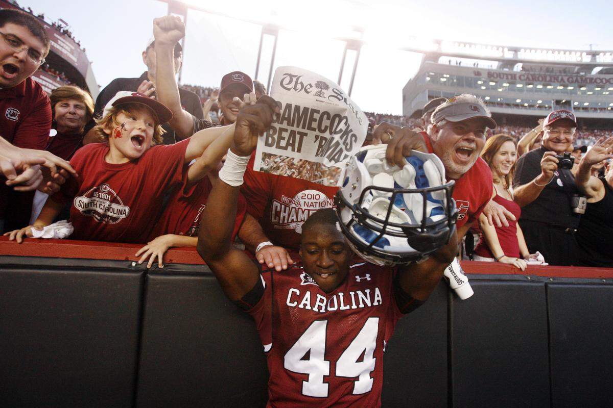 From Oct. 9, 2010: South Carolina linebacker Tony Straughter celebrates with fans after the Gamecocks’ win over Alabama at Williams-Brice Stadium.