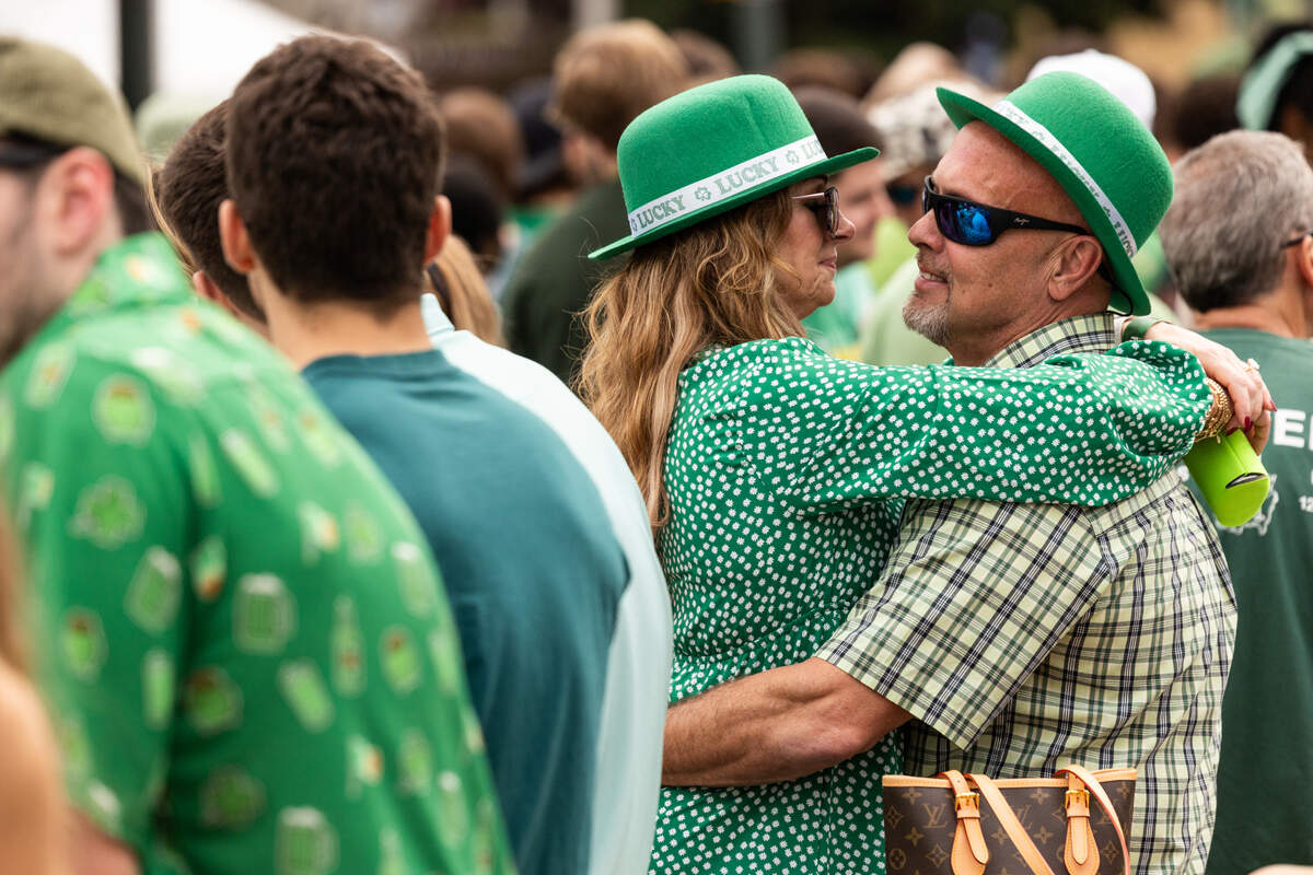 A couple holds each other during the St. Pat’s in Five Points festival in Columbia, South Carolina on Saturday, March 15, 2025.