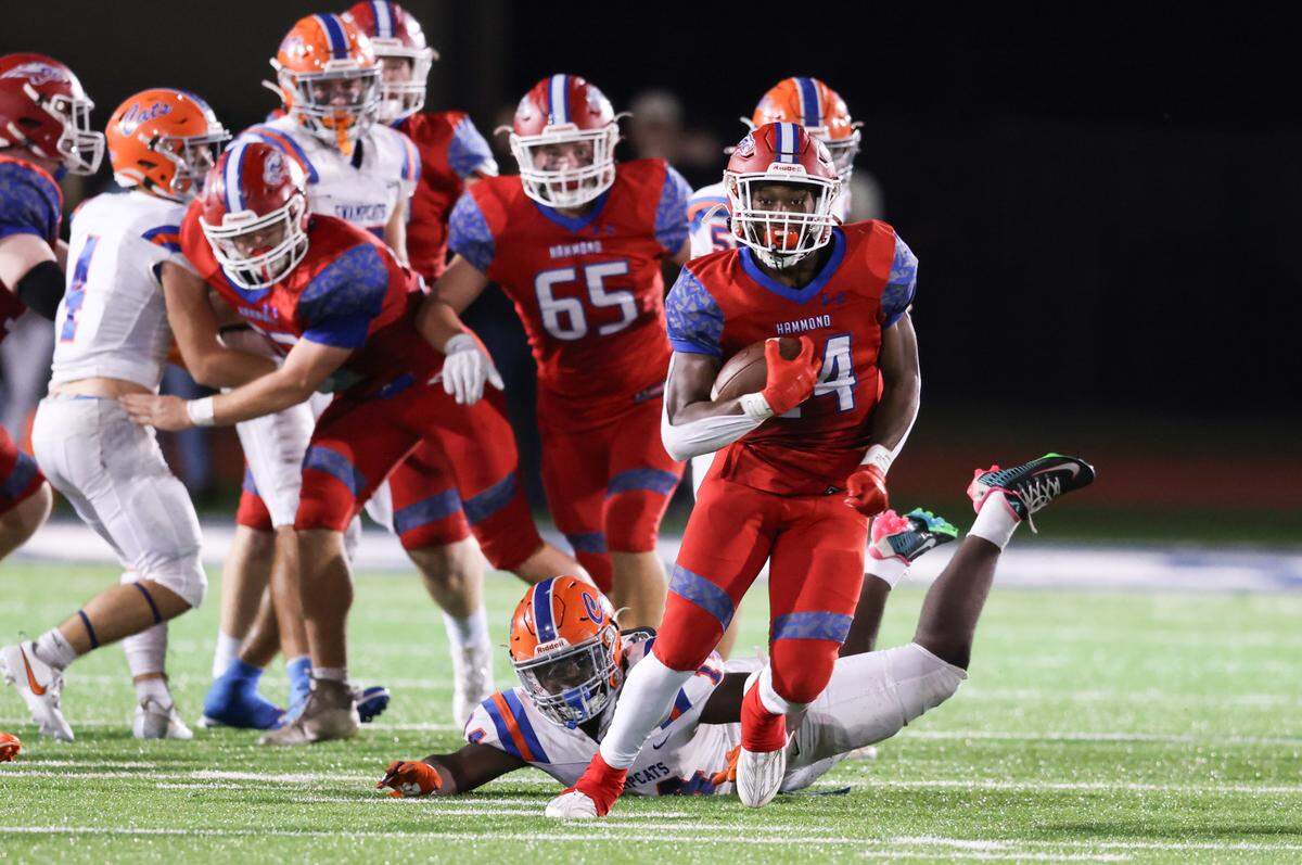 Immanuel Johnson (24) of Hammond jumps the tackle of Jeremiah Burson (14) of Laurence Manning and carries the ball for a touchdown during Hammond’s win in the 2023 SCISA Class 4A championship against Laurence Manning at Charleston Southern on Friday, November 17, 2023.