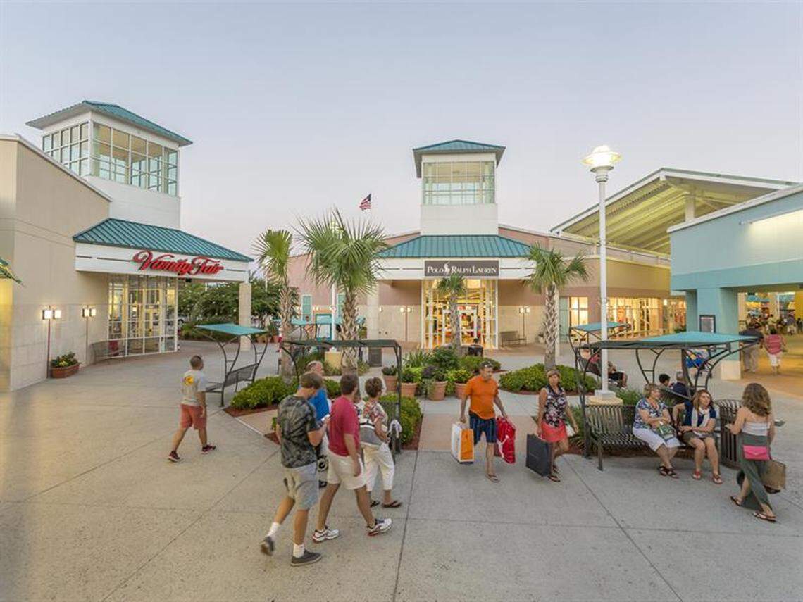 Shoppers wander through the newly remodeled Tanger Outlets shopping center in 2018.