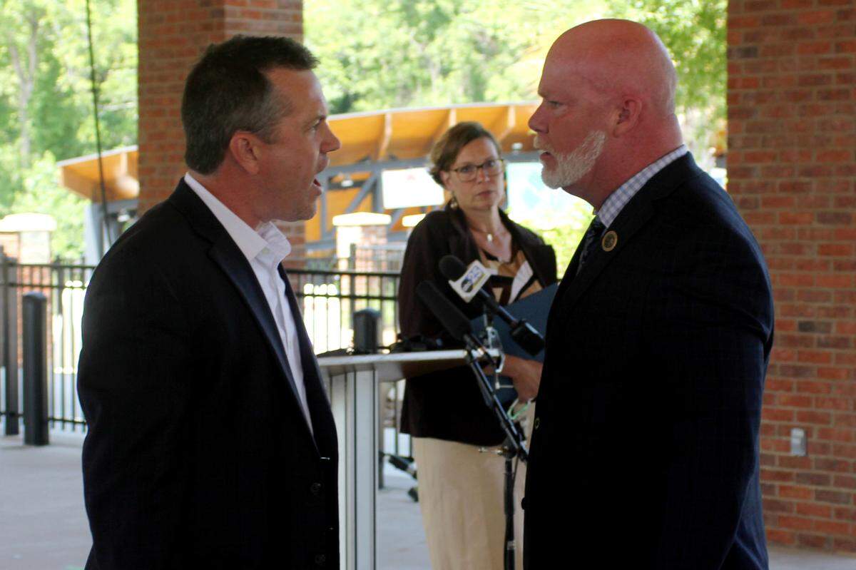 Lexington County Council Member Scott Whetstone (right) and council candidate Brent Munnerlyn shout in each other’s faces during a May 24, 2024 press conference.