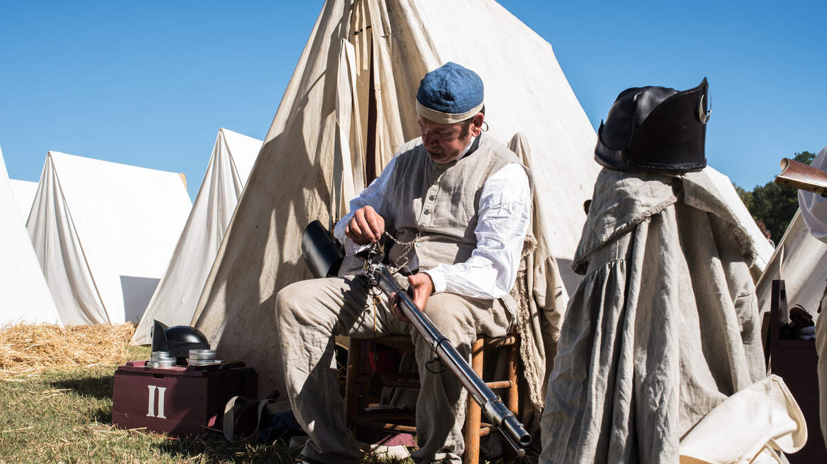 Re-enactor Huger McClellan cleans his musket after a battle demonstration during Revolutionary War Days in Camden, SC
