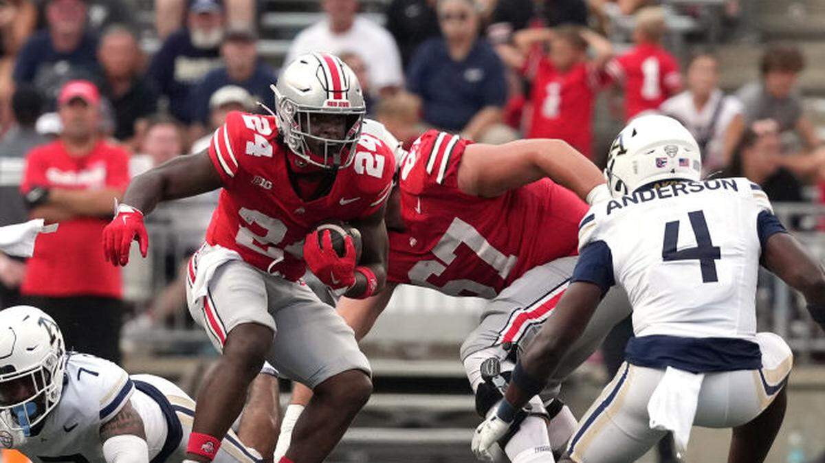Sam Williams-Dixon of the Ohio State Buckeyes carries the ball during the fourth quarter in against the Akron Zips at Ohio Stadium on August 31, 2024 in Columbus, Ohio.