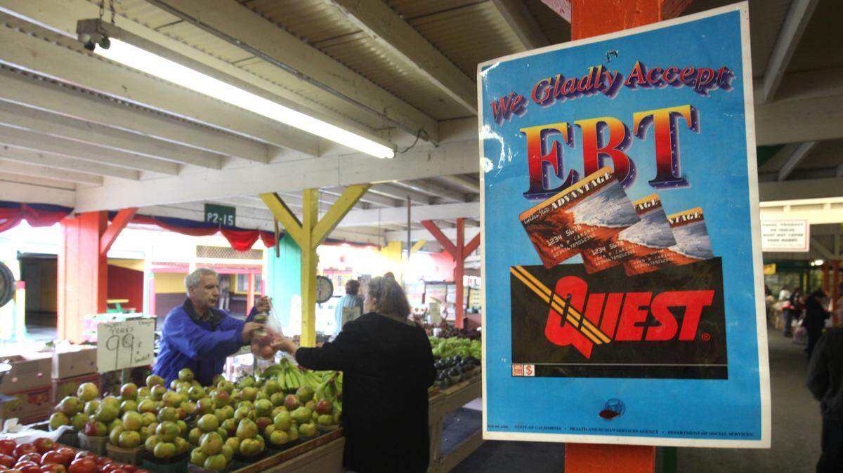 In this photo taken Saturday, Feb. 6, 2010, a sign announcing the acceptance of electronic Benefit Transfer cards is seen at a farmers market in Roseville, Calif. Currently food stamp recipients have had problems purchasing food at farmer’s markets because many of them do not accept the EBT cards that food stamp recipients use to buy groceries. A bill currently in the legislature would change that by helping farmers markets overcome bureaucratic hurdles to obtain the equipment needed to read the benefit cards.(AP Photo/Rich Pedroncelli)