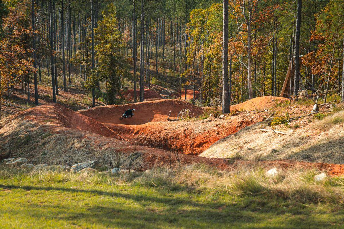 A rider rounds curves on a trail during opening day at Fairfield County’s Rattlesnake Bike Park. Nov. 16, 2024.