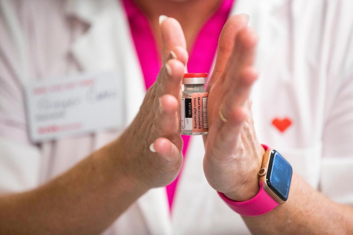 Pharmacist Ginger Cates defrosts a Moderna coronavirus vaccine at Wellmore of Lexington on Wednesday, December 30, 2020. The vaccine is transported frozen and must be thawed before injected.