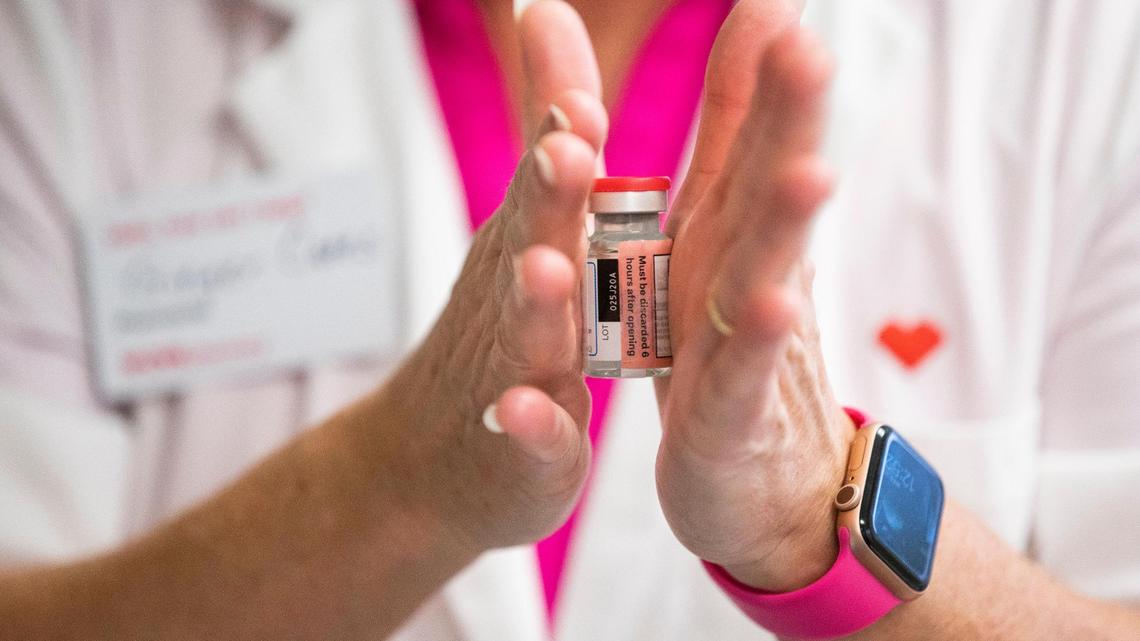 Pharmacist Ginger Cates defrosts a Moderna coronavirus vaccine at Wellmore of Lexington on Wednesday, December 30, 2020. The vaccine is transported frozen and must be thawed before injected.