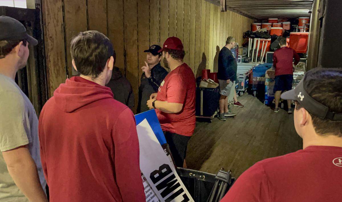 Students load up the semi-truck hauling all the Gamecocks football teams’s equipment for a road game.