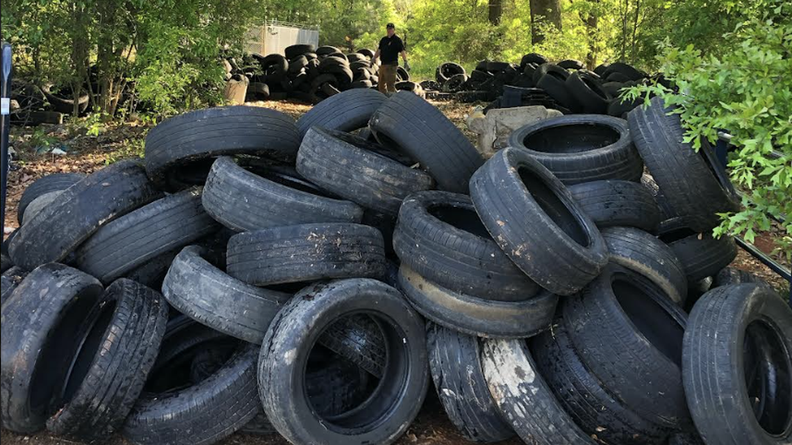 A Greenville man has been accused of illegally dumping thousands of tires in various wooded areas of teh Upstate.