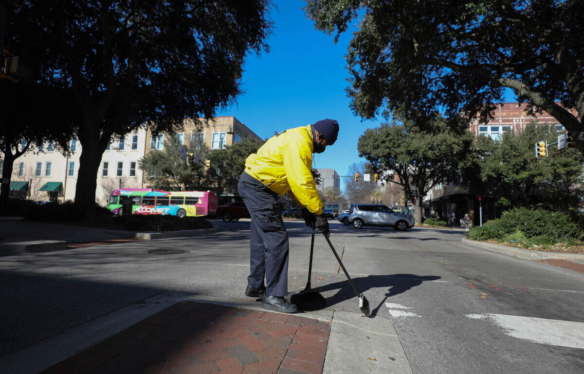 Herman Green sweeps along Columbia’s Main Street. The Yellow Shirts, employed through City Center Partnership work daily around Main Street, keeping things tidy, offering security and providing information.