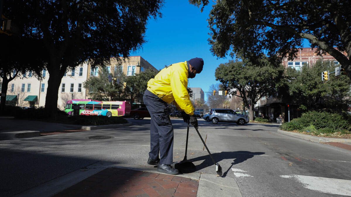 Herman Green sweeps along Columbia’s Main Street. The Yellow Shirts, employed through City Center Partnership work daily around Main Street, keeping things tidy, offering security and providing information.
