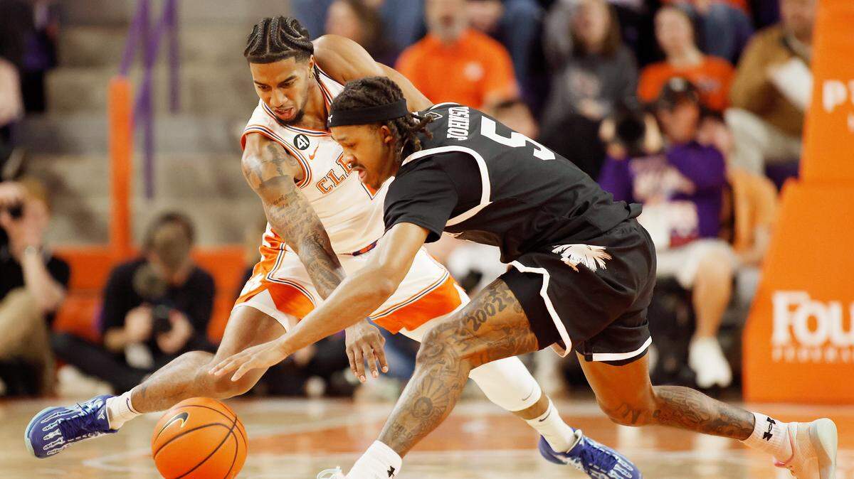 South Carolina guard Meechie Johnson (5) and Clemson guard Dillon Hunter (2) chase down a loose ball during first-half action in Clemson, S.C. on Tuesday, Dec. 16, 2025.