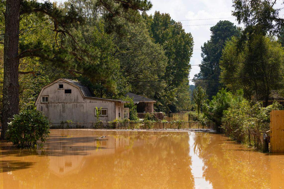 Water flows through the yards and floods homes on Brookcliff Road in Cayce, South Carolina as water from Hurricane Helene floods the Congaree River on Monday, September 30, 2024.