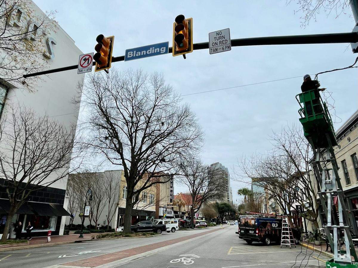 Workers prepare to hang a “ceiling of lights” in the 1600 block of Main Street on Wednesday, Dec. 14. The lights will be on nightly year-round.