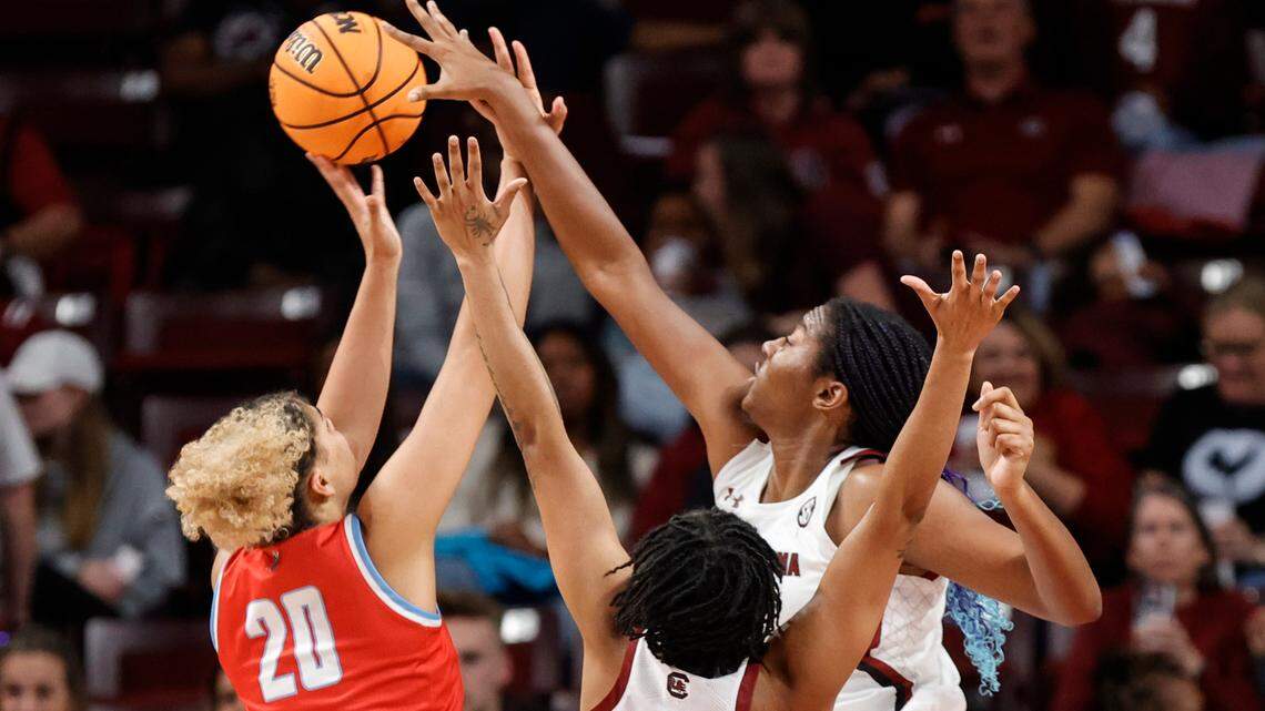 South Carolina’s Aliyah Boston (4) and Kierra Fletcher (41) block Liberty’s Mya Berkman (20) during the first half of action in the Colonial Life Arena on Sunday, Dec. 11, 2022.