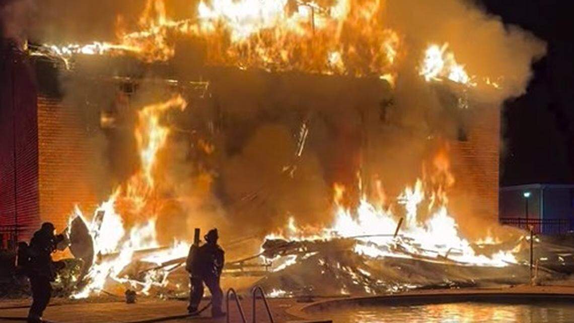 Fire and smoke billow through top of burning building in Columbia, officials say