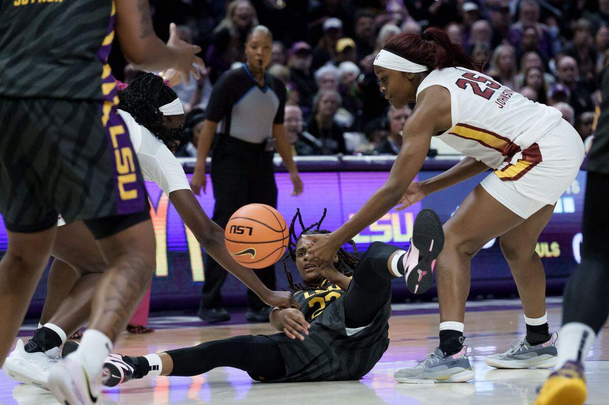 LSU guard MiLaysia Fulwiley (23) steals the ball away from South Carolina guard Raven Johnson (25) during the first half of an NCAA basketball game on Saturday, Feb. 14, 2026, at Pete Maravich Assembly Center in Baton Rouge, Louisiana.