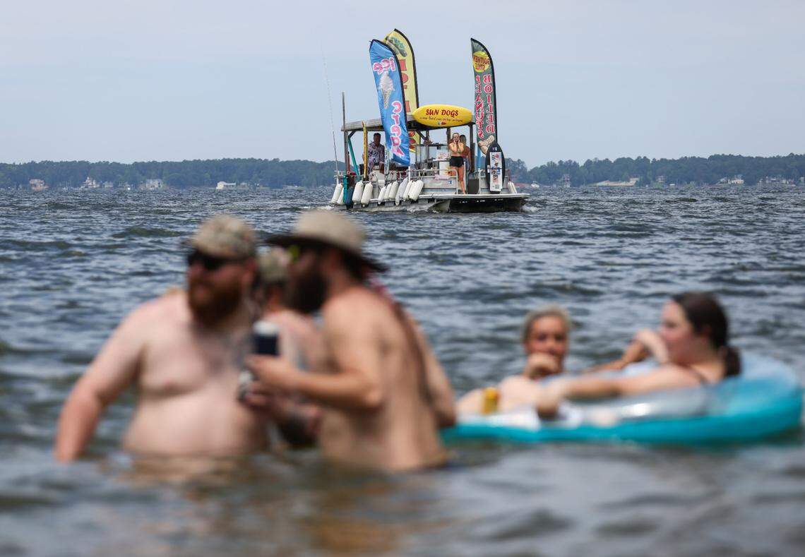 The Sun Dogs boat, which sells hot dogs and other foods, pulls up to prospective customers spending Memorial Day at Sandy Beach on Bundrick Island on Lake Murray in Lexington on Monday, May 27, 2024.