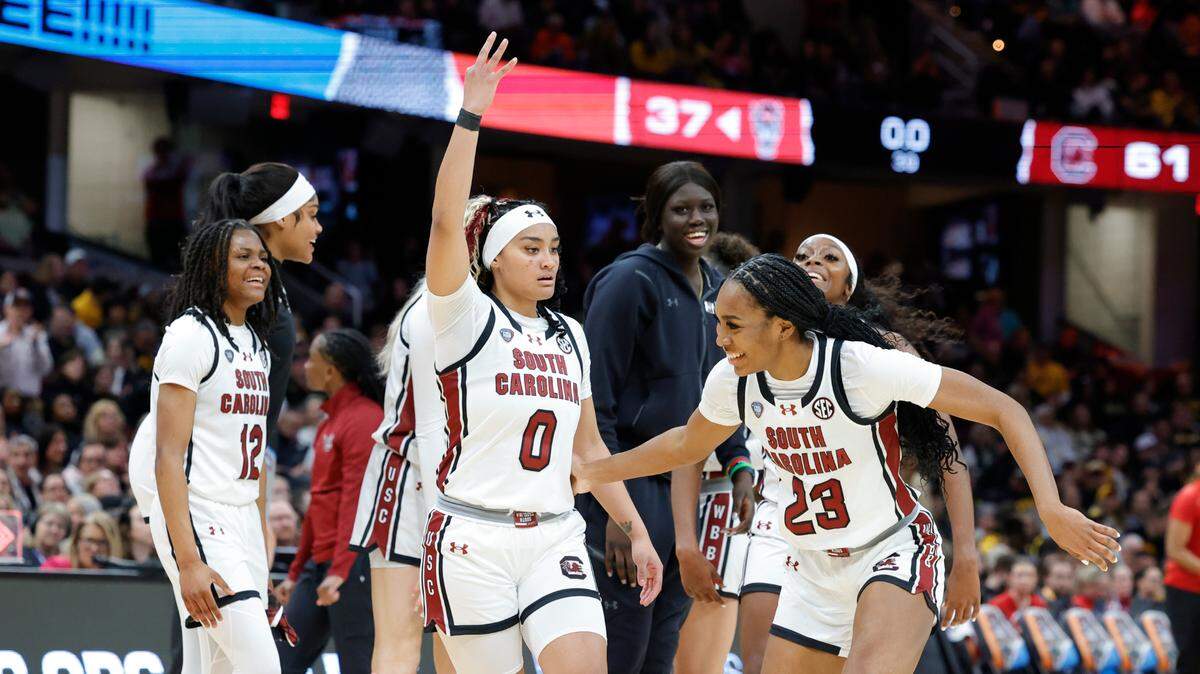 South Carolina’s Te-Hina Paopao (0) and Bree Hall (23) celebrate after shooting a string of three-pointers during the Final Four game against NC State at Rocket Mortgage FieldHouse in Cleveland, Ohio on Friday April 5, 2024.