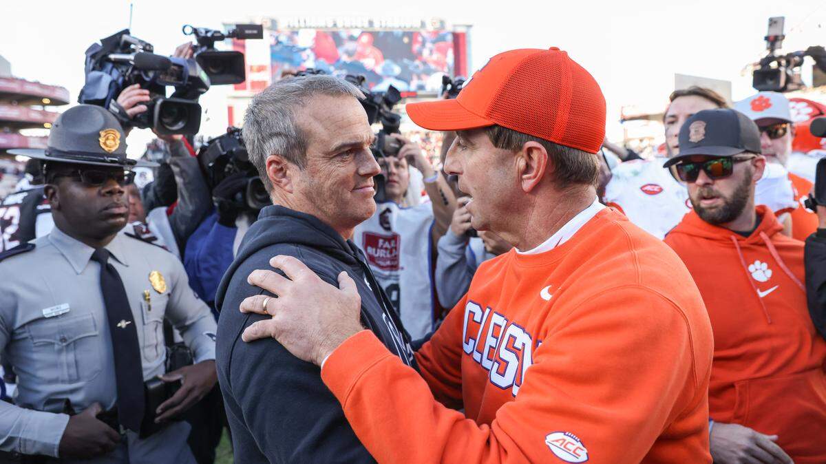 South Carolina head coach Shane Beamer meets with Clemson head coach Dabo Swinney at midfield following South Carolina’s loss to Clemson at Williams-Brice Stadium in Columbia on Saturday, November 29, 2025.