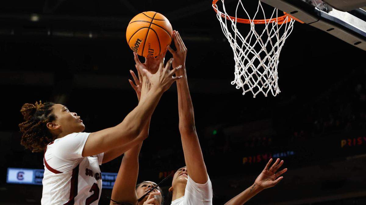 South Carolina’s LeLe Grissett (24) and Kamilla Cardoso (10) pull down a rebound with Texas’s Jada Malone (13) during the first half of action on Thursday Jan, 13, 2022 in the Colonial Life Arena.