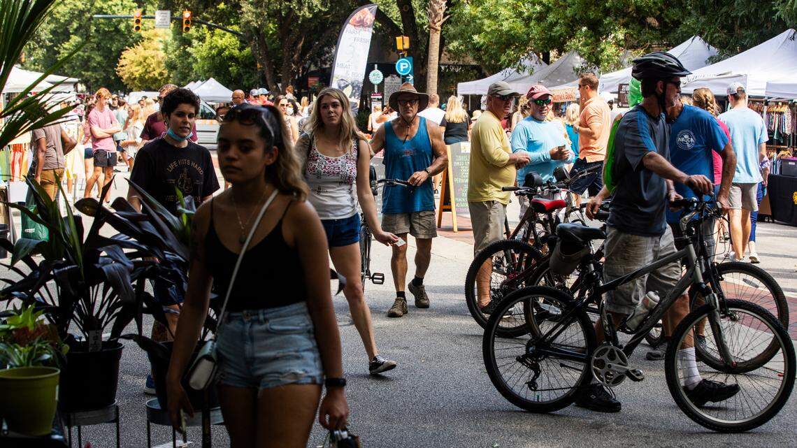 People shop at Soda City Market in downtown Columbia, South Carolina on Saturday, August 21, 2021. The market stretches multiple blocks with vendors from all over South Carolina.