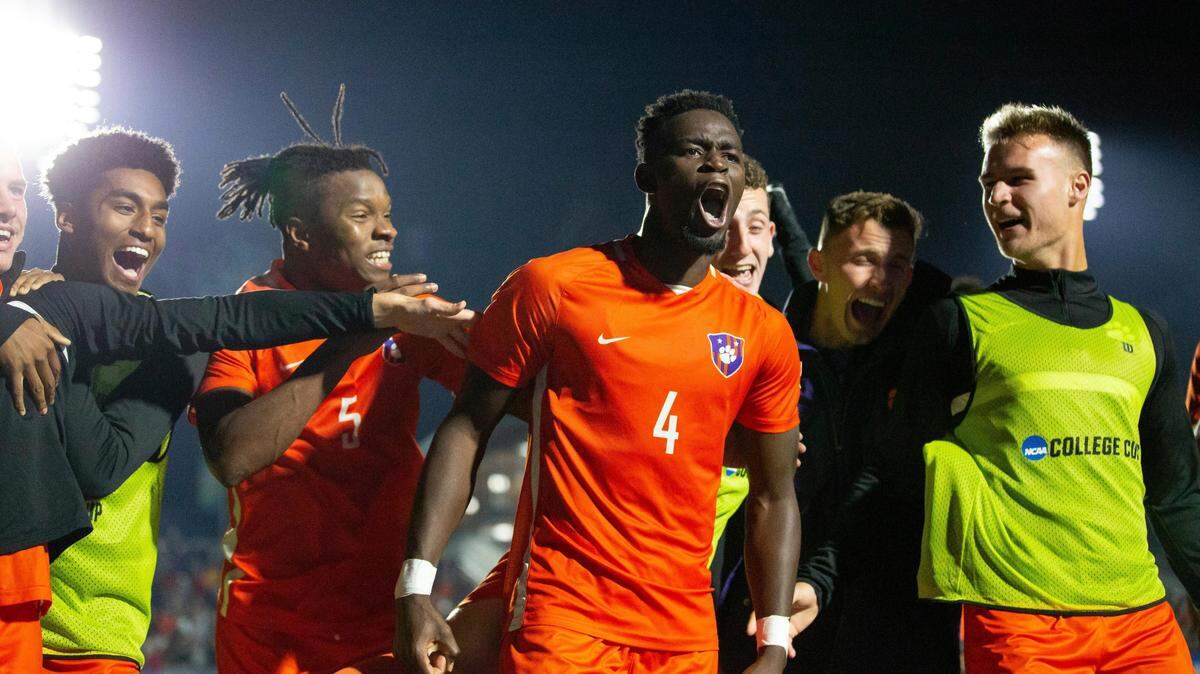 Clemson’s Justin Malou (4) celebrates with teammates after scoring the winning penalty kick against Notre Dame in a soccer semifinal of the NCAA College Cup in Cary, N.C., Friday, Dec. 10, 2021. (AP Photo/Ben McKeown)