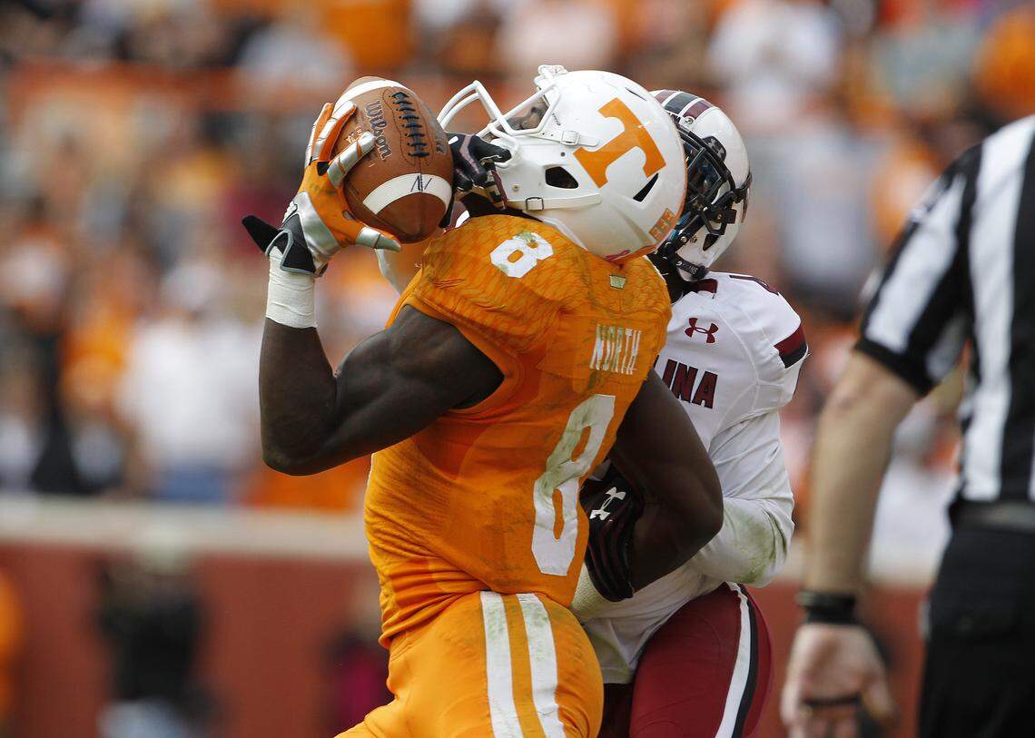 Tennessee Volunteers wide receiver Marquez North (8) makes an acrobatic one-handed catch in front of South Carolina Gamecocks cornerback Ahmad Christian (4) to keep their drive alive in the fourth quarter at Neyland Stadium in Knoxville, TN, Saturday, October 19, 2013.