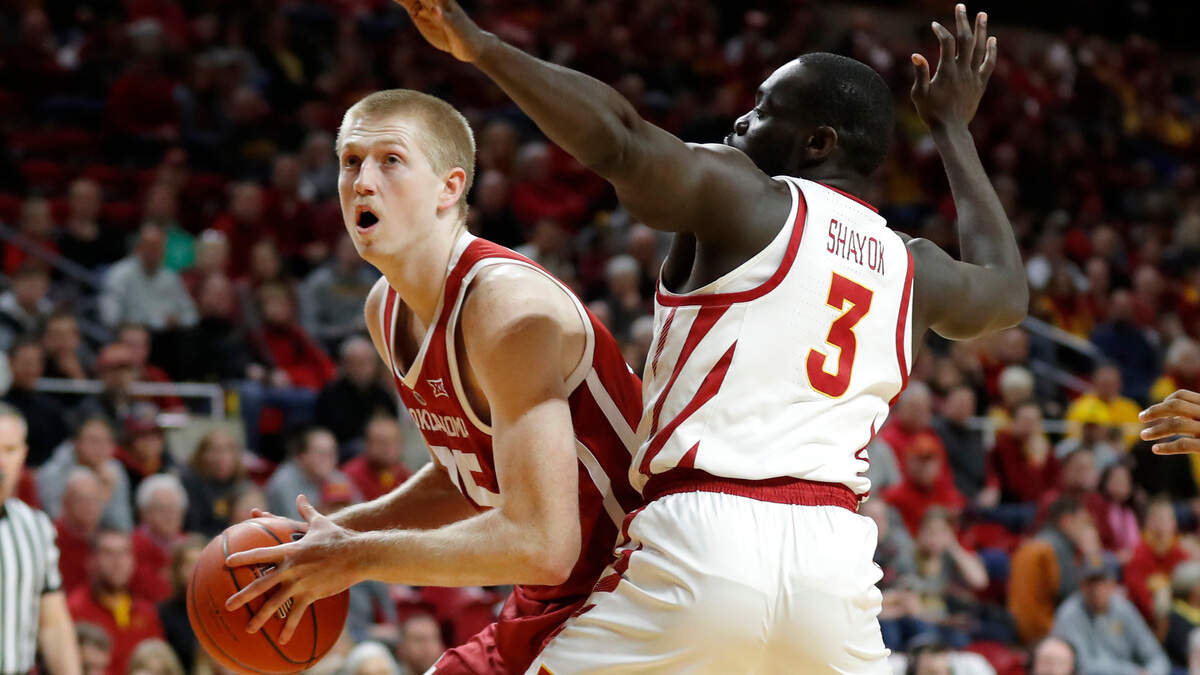 Oklahoma forward Brady Manek drives past Iowa State guard Marial Shayok, right, during the first half of an NCAA college basketball game, Monday, Feb. 25, 2019, in Ames, Iowa. (AP Photo/Charlie Neibergall)