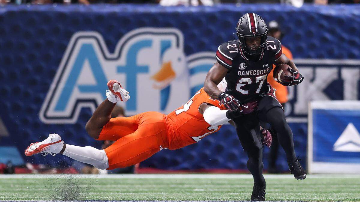South Carolina running back Oscar Adaway III (27) breaks the tackle of Virginia Tech linebacker Jaden Keller (24) Sunday at Mercedes-Benz Stadium in Atlanta. The Gamecocks and Hokies faced off Aug. 31 in the 2025 Aflac Kickoff Game.