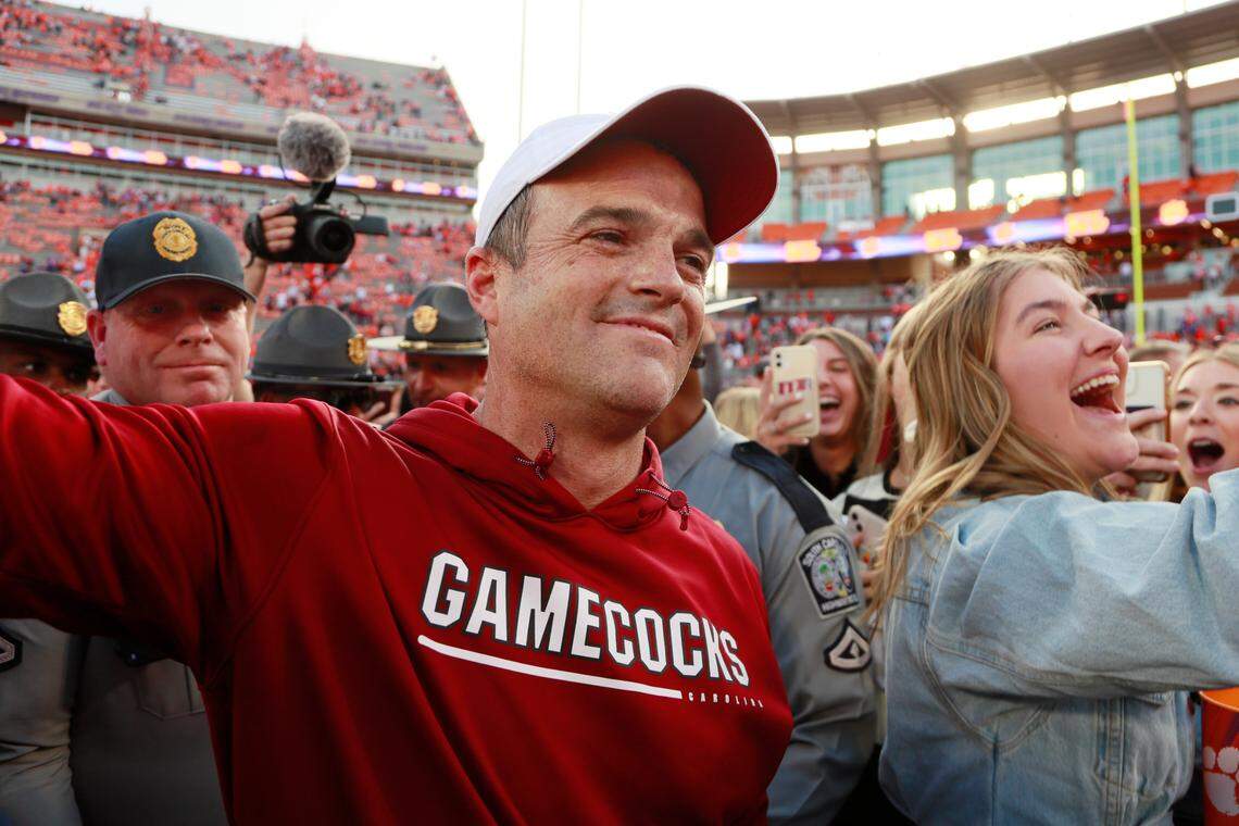 South Carolina Gamecocks head coach Shane Beamer wades through masses of fans after his team beat Clemson on Saturday, November 26, 2022.