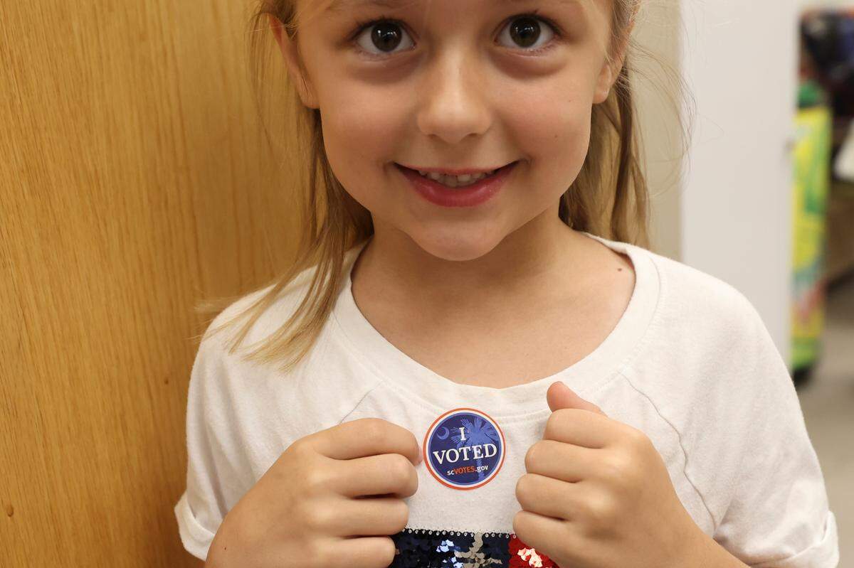 Addison Rikard, 7, shows off her ‘I Voted’ sticker after her family voted on Tuesday, Nov. 5, 2024 at Hand Middle School on