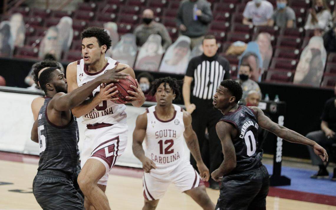 South Carolina Gamecocks forward Justin Minaya (10) is blocked by Texas A&M Aggies forward Jonathan Aku (15) at Colonial Life Arena on Wednesday, January 6, 2021.