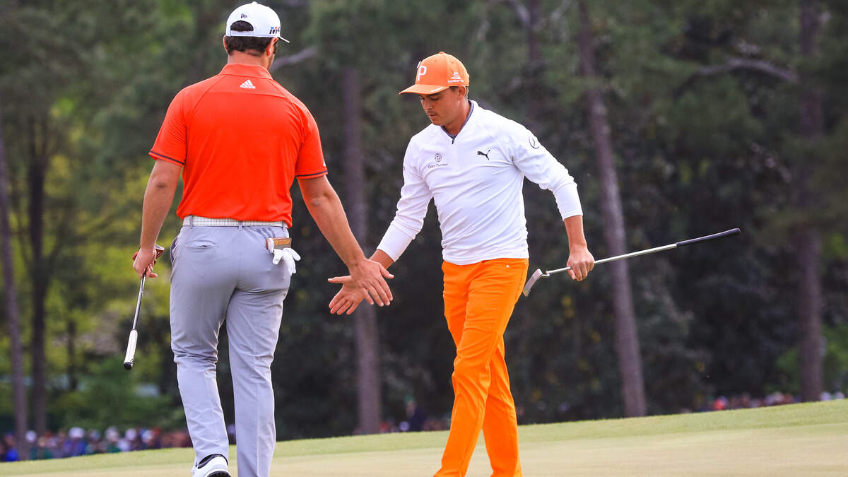 Rickie Fowler is congratulated by Jon Rahm after he made a birdie putt on 18 during the fourth round of the 2018 Masters golf tournament, Sunday April 08, 2018, in Augusta, Ga. Fowler finished second. 