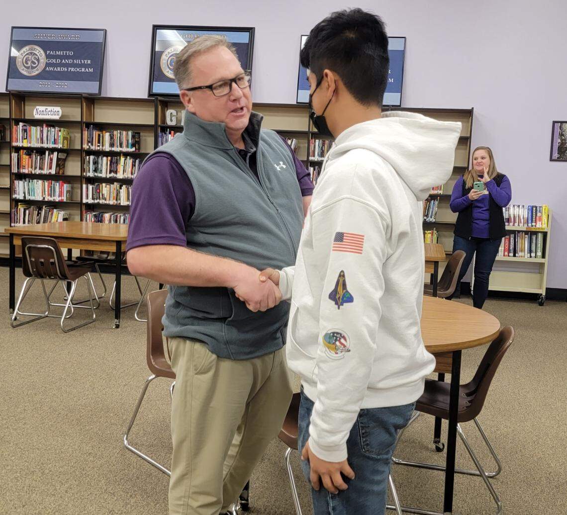 Batesburg-Leesville football coach Gene Cathcart, left, talks with B-L players at an introductory press conference on Jan. 13, 2022.