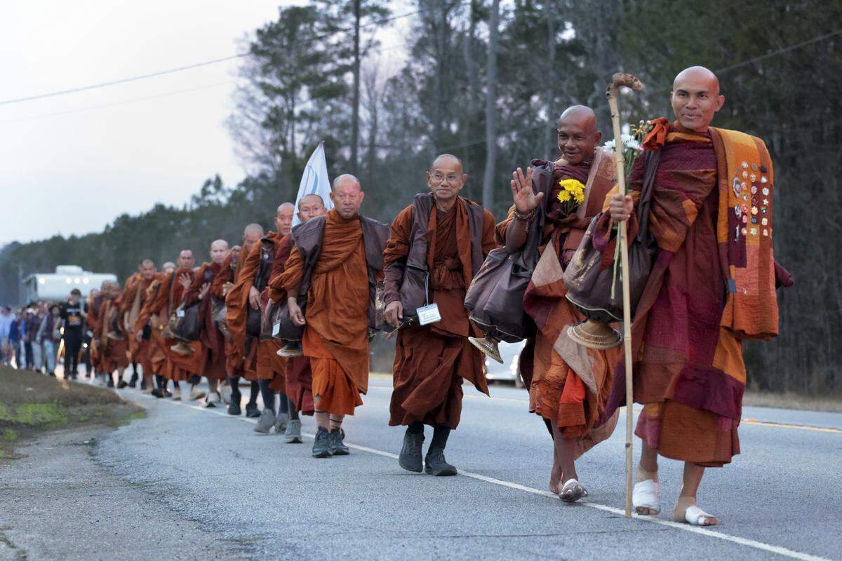 A group of Buddhist monks walk along U.S. 378 in Saluda County with the Walk for Peace on Thursday, Jan. 8, 2026. The group of Buddhist monks is walking 2,300 miles, from Fort Worth, Texas to Washington D.C. spreading a message of peacefulness.