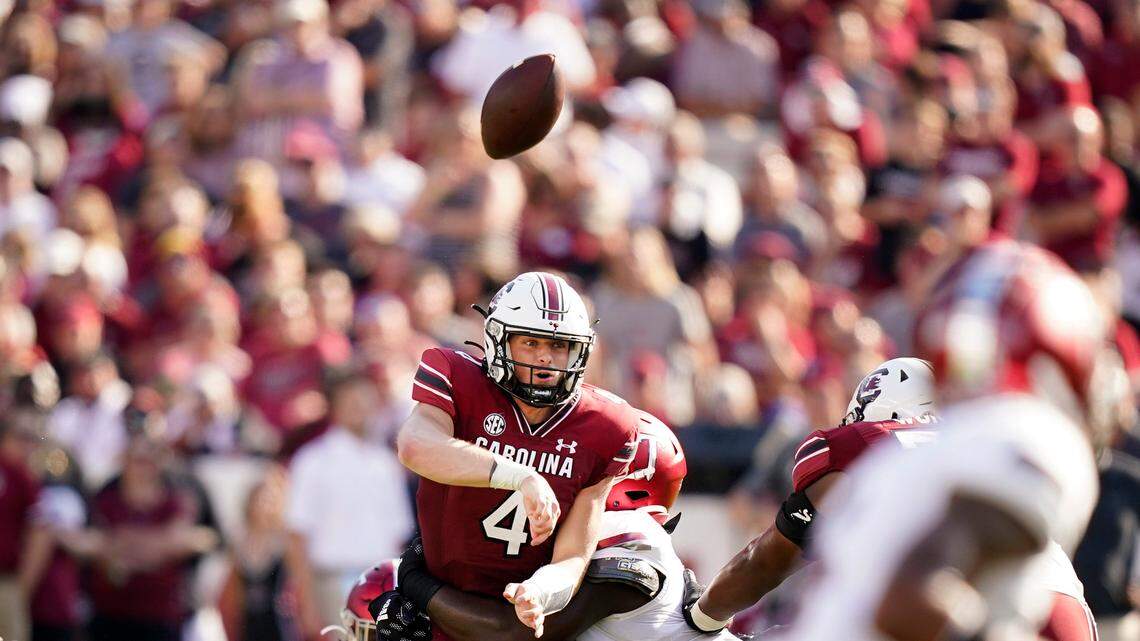 South Carolina quarterback Luke Doty (4) is tackled as he throws the ball in the first half of an NCAA college football game against Troy, Saturday, Oct. 2, 2021, in Columbia, S.C. (AP Photo/Brynn Anderson)