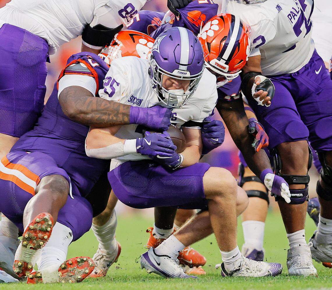 Furman running back Ben Croasdale (25) is wrapped up by Clemson during first-half action in Clemson, S.C. on Saturday, Nov. 22, 2025.