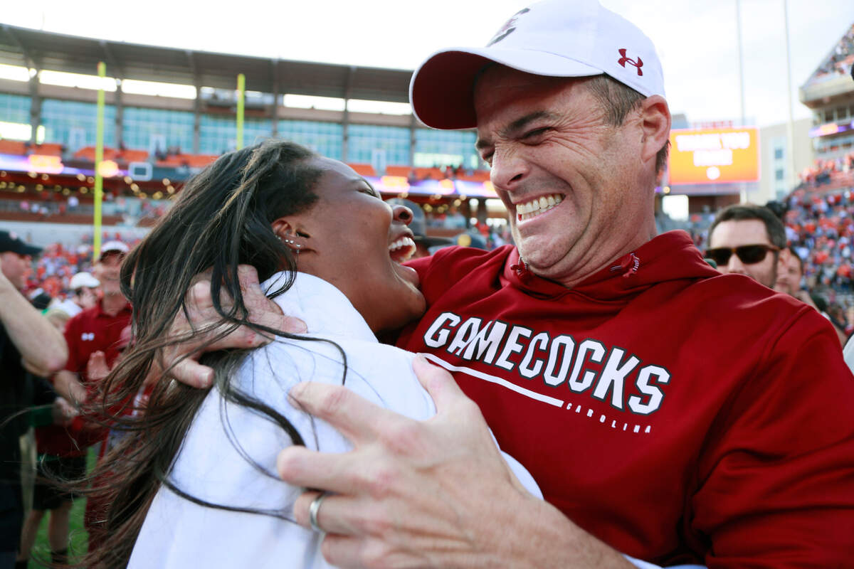 South Carolina Gamecocks head coach Shane Beamer wades through masses of fans after his team beat Clemson on Saturday, November 26, 2022.