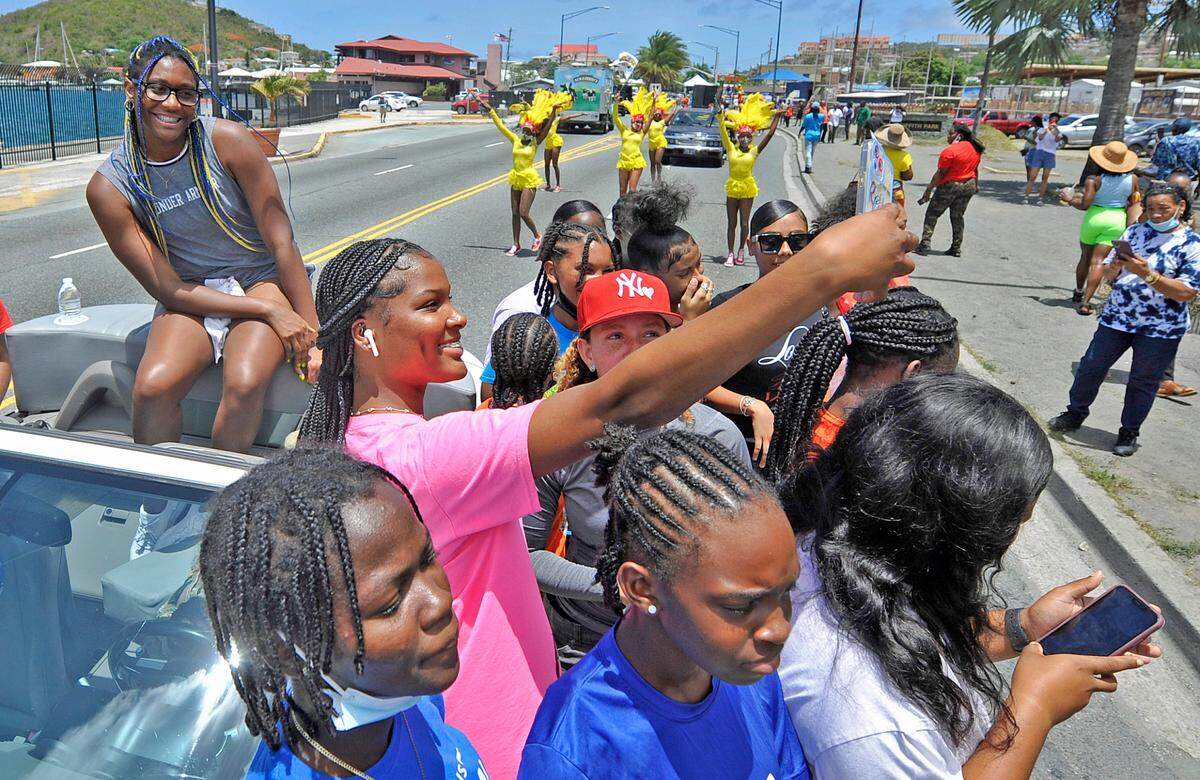 A parade-goer takes a selfie with South Carolina forward and St. Thomas native Aliyah Boston during the “Aliyah Boston Day” parade down Veterans Drive in downtown Charlotte Amalie, St. Thomas, U.S. Virgin Islands, on Saturday, June 4, 20022.