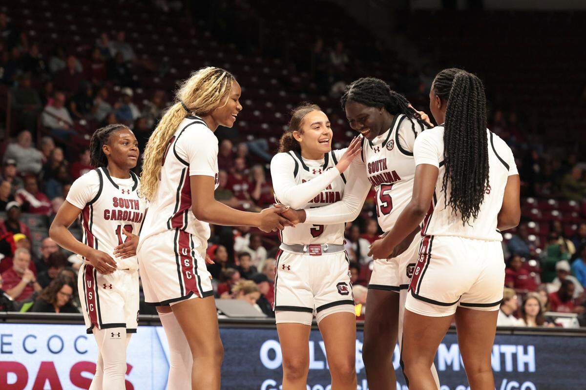 Teammates surround University of South Carolina forward Adhel Tac (15) after she made a play during the second half of action against Clayton State in the Colonial Life Arena on Monday, Oct. 28, 2024.