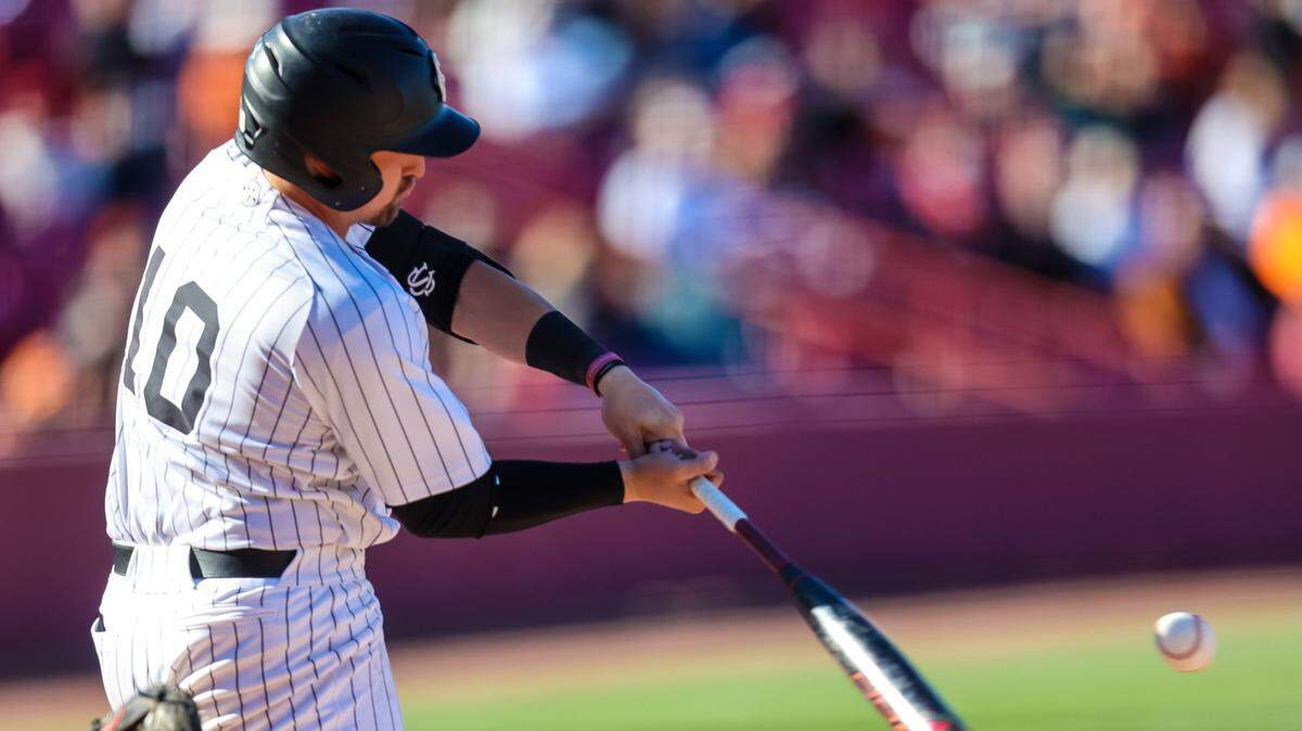 South Carolina Gamecocks catcher Colin Burgess (10) gets a base hit against the Texas Longhorns during the second game game of their double header at Founders Park Sunday, March 13, 2022.