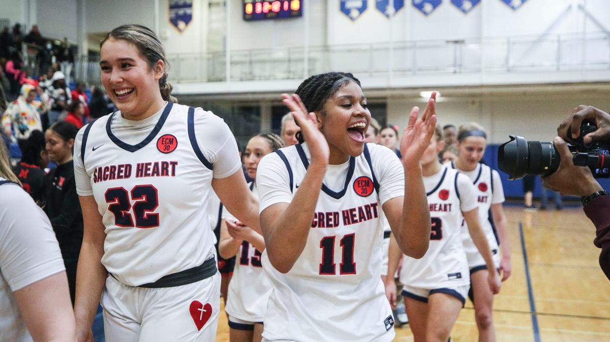 Sacred Heart’s ZaKiyah Johnson celebrates with her teammates after the Valkyries defeated Manual at the 2023 Seventh Region semifinal Thursday March 2, 2023.