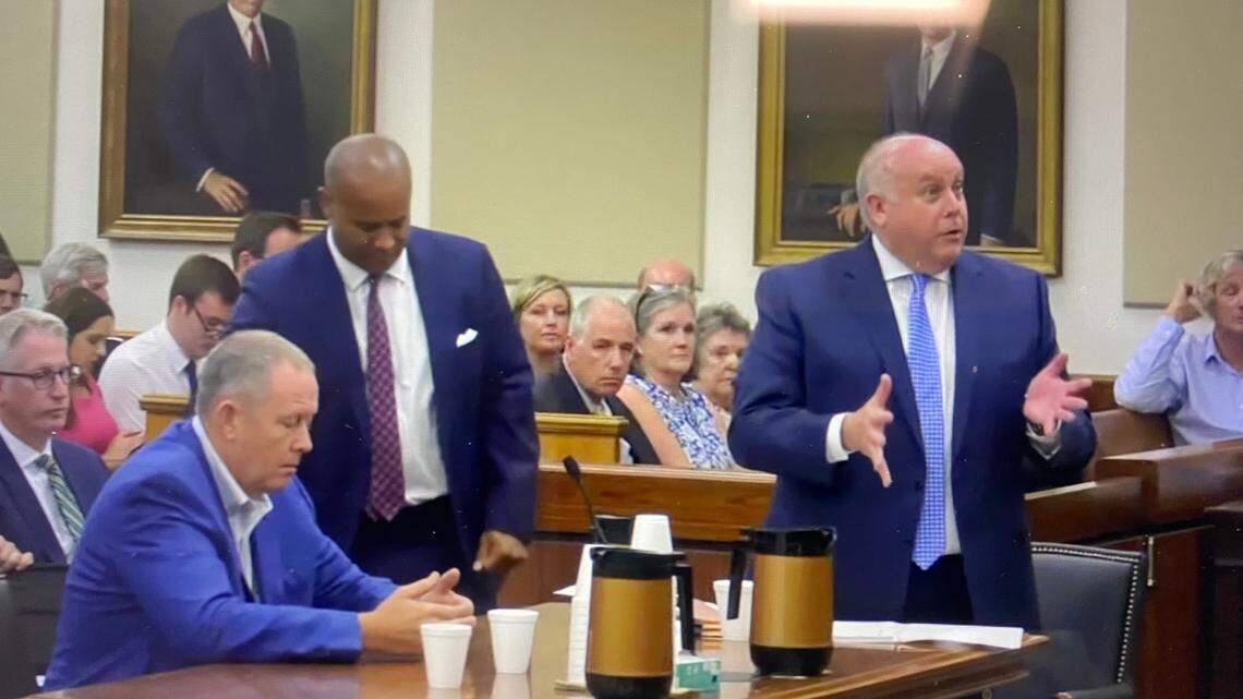Attorneys Mark Moore (right) and Todd Rutherford (center), successfully argued for a delay Thursday having a trial date set for their client, Russell Laffitte (center). Laffitte faces numerous financial crimes charges.