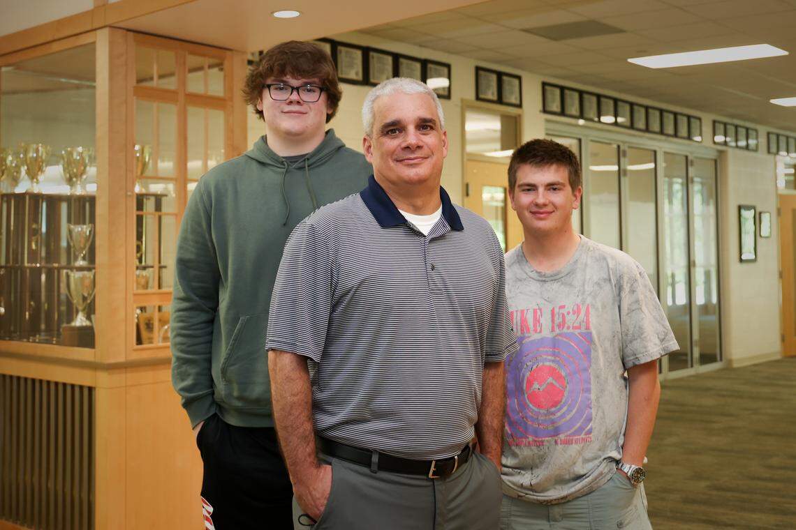 River Bluff High School teacher Michael Burgess, center, and students, including Cooper Dempsey, left, Kyle Lam, right have been studying about the lynching of Willie Leaphart. 