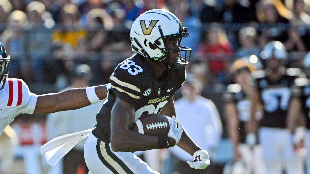 Vanderbilt wide receiver Gamarion Carter (83) runs as Mississippi linebacker Troy Brown (8) defends during the first half of an NCAA college football game Saturday, Oct. 8, 2022, in Nashville, Tenn. (AP Photo/John Amis)