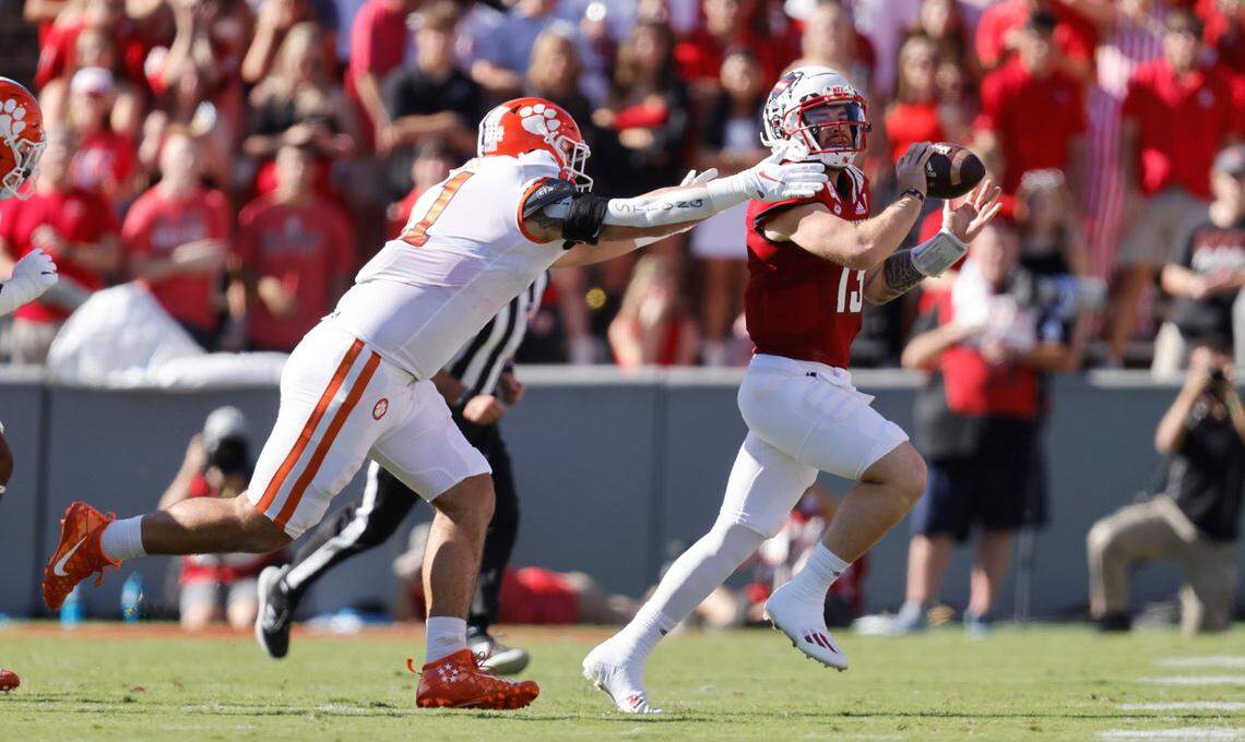 N.C. State quarterback Devin Leary (13) tries to escape from Clemson defensive lineman Bryan Bresee (11) during the first half of N.C. States game against Clemson at Carter-Finley Stadium in Raleigh, N.C., Saturday, Sept. 25, 2021.