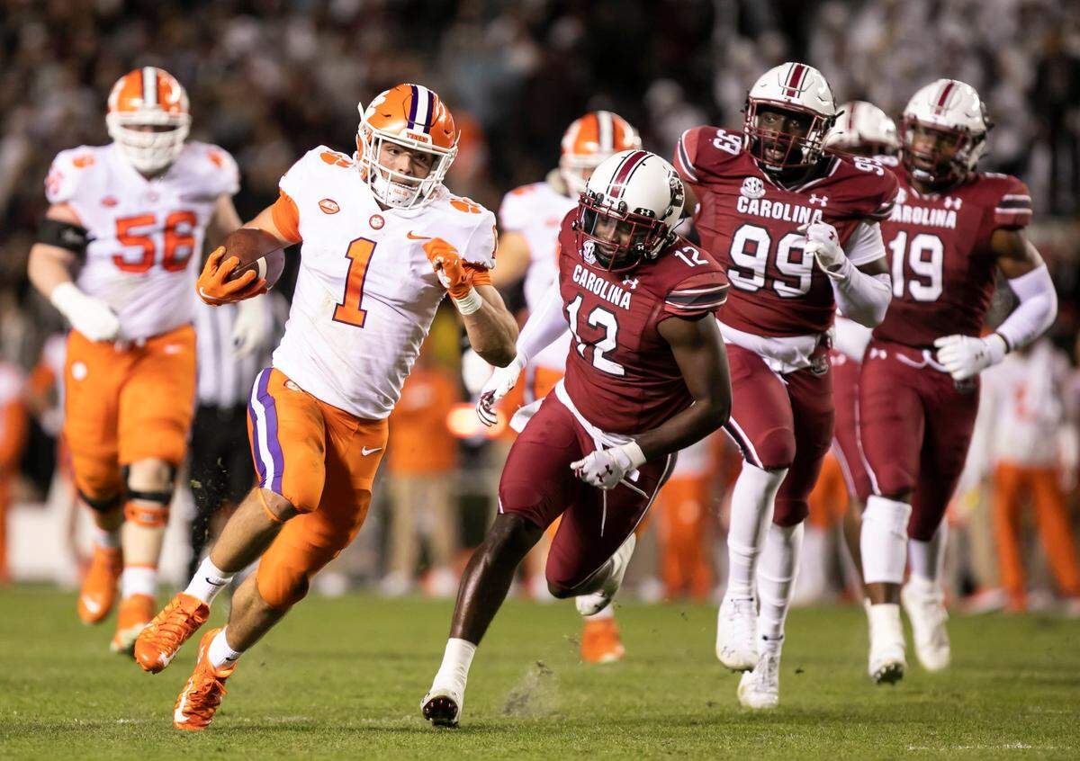 Will Shipley of Clemson carries the ball in for a touchdown as Jaylan Foster and teammates give chase during the Gamecocks’ game against Clemson at Williams-Brice Stadium on Saturday, November 27, 2021.