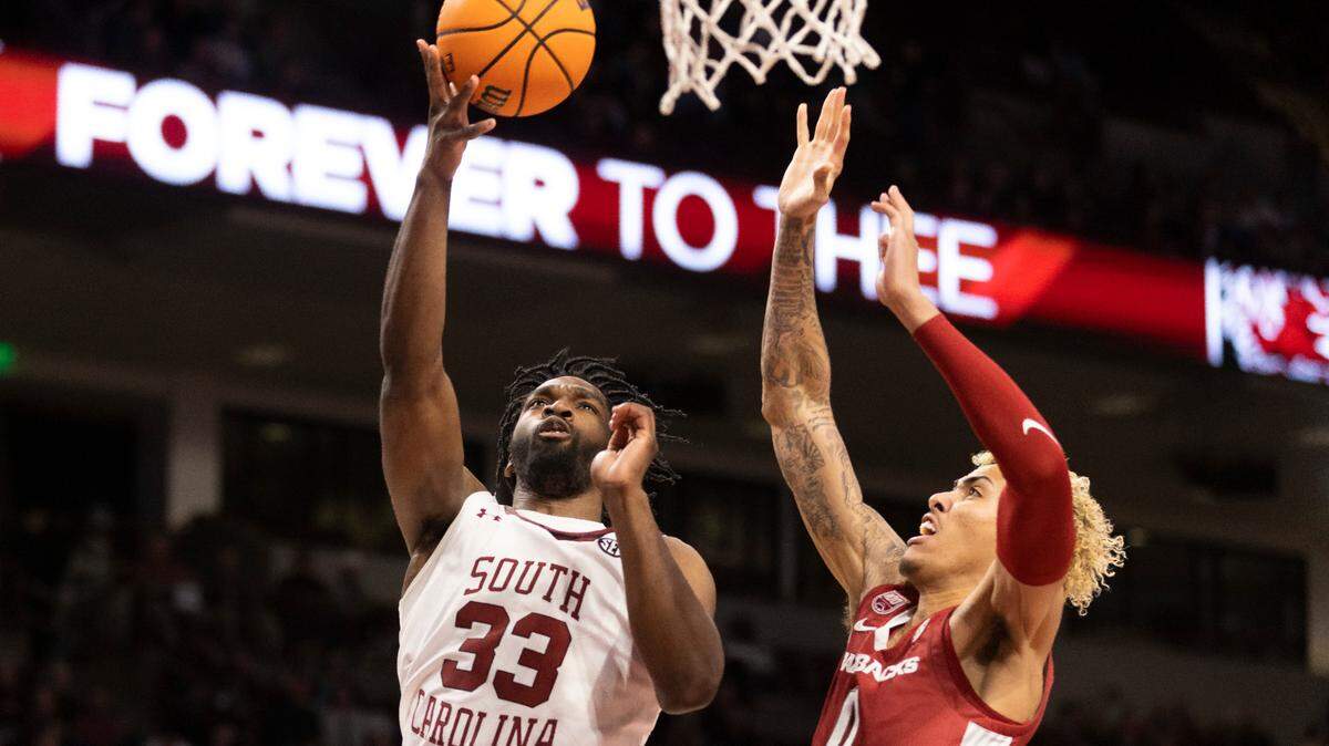 South Carolina Gamecocks forward Josh Gray (33) puts up a layup as Arkansas Razorbacks forward Jalen Graham (11) tries to defend during South Carolina’s game against the visiting Razorbacks at Colonial Life Arena in Columbia on Saturday, February 4, 2023.