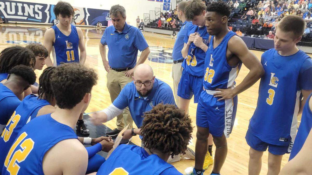 The Lexington boys basketball team during a timeout Monday in the 2023 Upper State championship game.